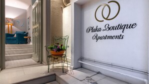 A boutique apartment entrance with a sign reading "Plaka Boutique Apartments." - Ipelhome Plaka Boutique Apartments (Athens)