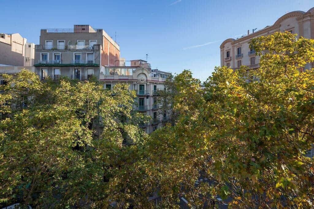 A multi-story building with balconies and a courtyard.