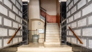 A grand staircase with marble steps leading to a landing. - Paseo de Gracia | Classy 3bed 3bath apartment (Barcelona)