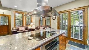 A kitchen with a granite countertop, stainless steel appliances, and a built-in oven. - Ridge Street Chalet B 2 Bedroom Townhouse by RedAwning (Breckenridge)