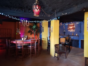A cozy dining area with a table and chairs, a hanging lantern, and a Christmas tree. - Waterfront 4 bedroom. Discount available for extended or monthly rentals! (Slidell)