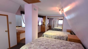 A bedroom with two beds, a wooden wardrobe, a mirror, and a ceiling light fixture. -  Charming  Cozy  Waterfront Cottage  (Val Des Bois)