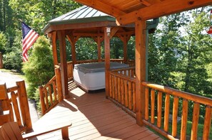 A wooden deck with a hot tub, surrounded by a wooden railing and a gazebo. - Cherokee Ridge Retreat (Whittier)