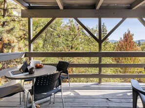 An outdoor patio with a round table, two chairs, and a bench. - Whispering Pines | Amazing Views | Family Fun (Lake Arrowhead)