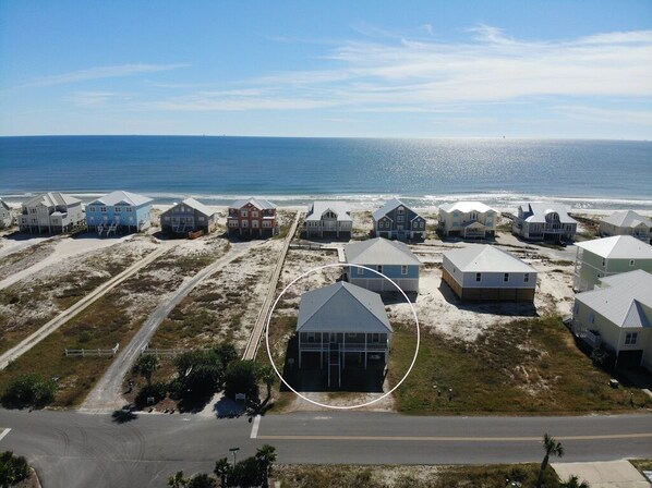 An aerial view of beach houses with a road in the foreground and the ocean in the background. - Great views and next to boardwalk! (Gulf Shores)