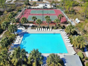 An aerial view of a resort with a swimming pool, tennis courts, and lounge chairs. - Great views and next to boardwalk! (Gulf Shores)