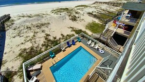 A pool area with a view of the beach and ocean. - Beachfront w/ Pool! Sleeps 20 (Gulf Shores)