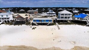 A coastal residential area with beachfront properties, including houses with balconies and beach access. - Beachfront & Dog Friendly! (Gulf Shores)