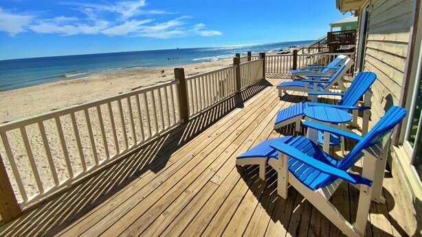 A wooden deck with blue chairs overlooking a beach. - Beachfront in Fort Morgan - Dogs OK (Gulf Shores)