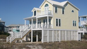 A two-story beach house with a balcony and a covered porch. - Great Gulf Views & Pools, Pickleball (Gulf Shores)