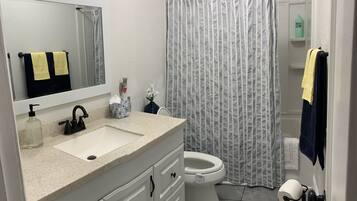 Combined shower/bathtub, towels, soap, toilet paper