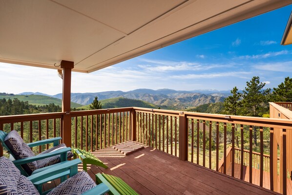 A wooden deck with a view of mountains. - Colorado Mountain Retreat with Unbeatable Views! (Livermore)