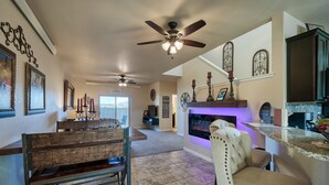 A spacious living room with a fireplace, a dining area with a wooden bench, and a kitchen with a granite countertop. - Beautiful Town Home in Poncha Springs- minutes to Monarch Mountain (Poncha Springs)