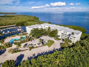An aerial view of a hotel with a pool, parking area, and a marina. - South Seas Bayside Villa 5344 (Captiva)