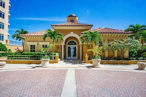 A hotel with a central entrance, arched doorway, and a dome-shaped roof.