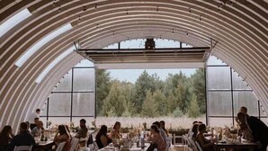 An indoor dining area with a curved ceiling and tables set for guests. - Ellison Bay Family Retreat! 8 bed/6 bath/20 acres (Ellison Bay)