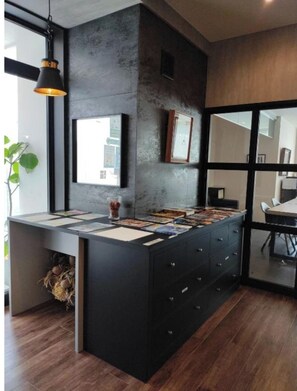 Modern kitchen with a central island, sink, and ample storage.