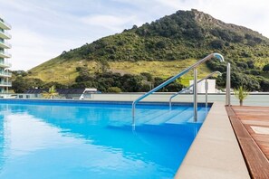 Outdoor pool, a heated pool - Exclusive Designer Apartment at Magical Mount Maunganui (Mount Maunganui)