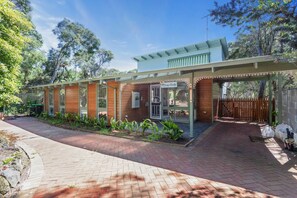 A two-story building with a covered patio area and a wooden facade. - Moonah Cottage Rye by Ready Set Stay- Close to the beach & WIFI (Rye)