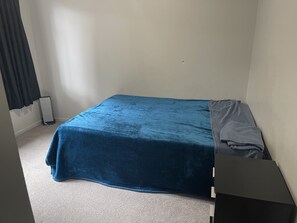 Cozy bedroom with a single bed, a small table, and a clean design.