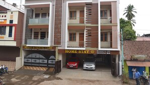 A multi-story building with a sign for 'Heart & Dental Care' and 'Home Stay @ Kommiya Inn'. - Kommiya Inn (Kumbakonam)