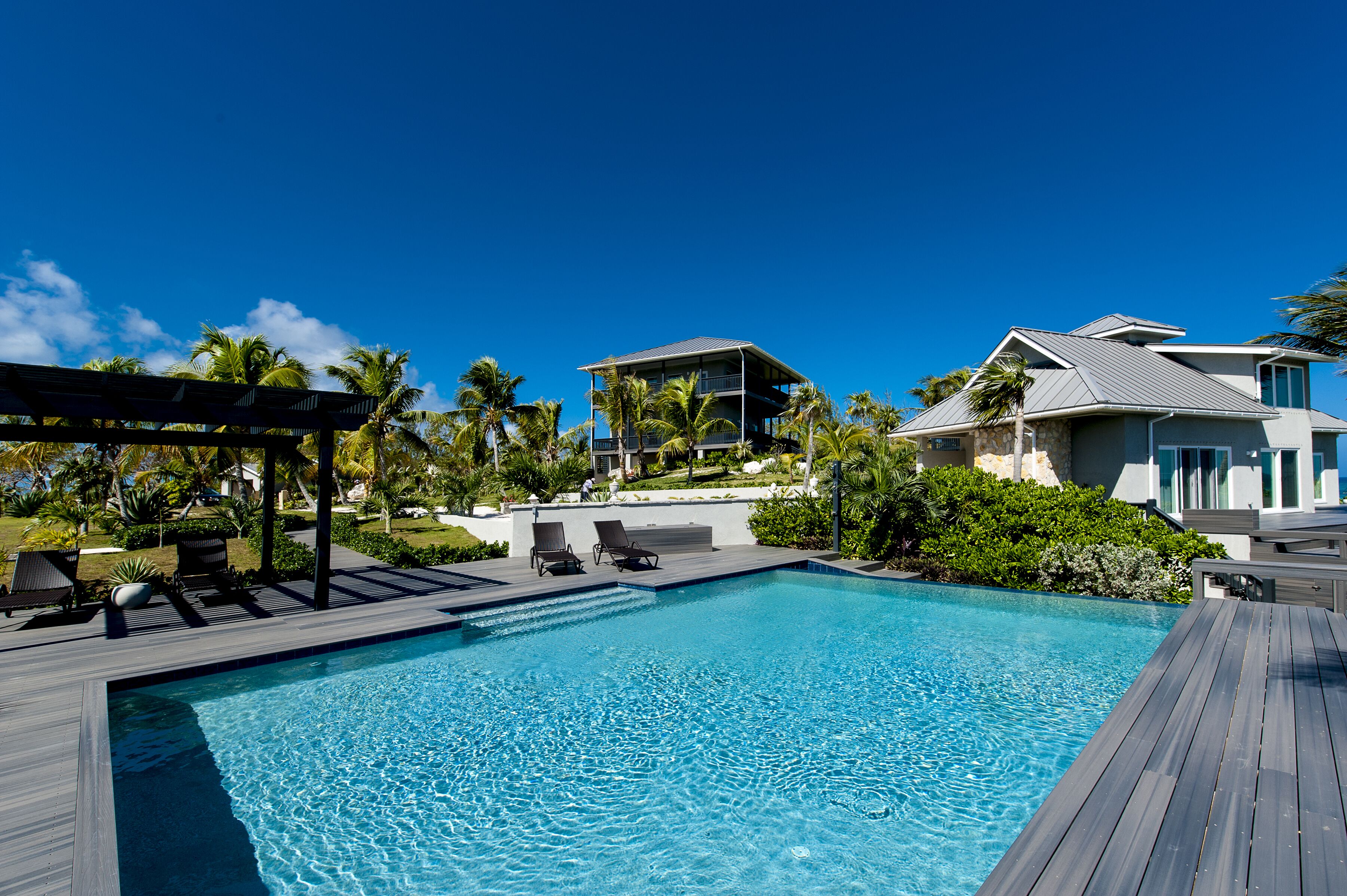 An infinity pool, a heated pool, sun loungers