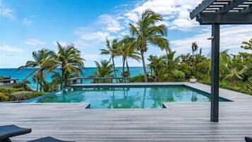 An infinity pool, a heated pool, pool loungers