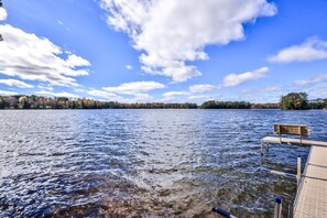 A lake with a wooden dock and a bench. - Gorgeous Private Home with magnificent lake views! Great Firepit to watch the Su (Harshaw)