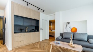 A modern kitchen with wooden cabinets and a built-in black countertop. - Triple A - Kolokotroni 62 (Athens)