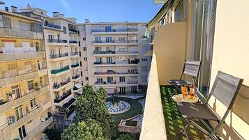A courtyard with a pool, surrounded by multi-story buildings with balconies.