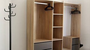 A room with a wooden wardrobe, a coat rack, and a bed. - GET ★ QUIET ★ WIFI TERRACE (Revel)
