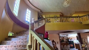 A multi-level interior with a spiral staircase, stone steps, and a decorative ceiling. -  QBR Balcony Suite (St. Joseph)