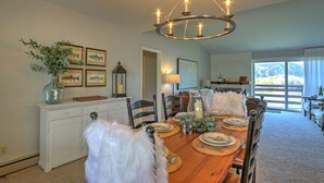 A dining room with a wooden table set for six, a chandelier, and framed fish pictures on the wall. - Condo on pond w/2 Fishing Badges, 24 Mi. to Aspen! (Carbondale)