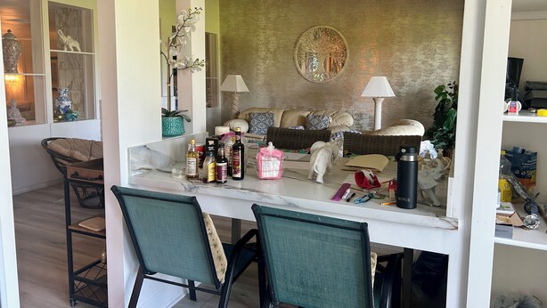 A cozy living area with a sofa, chairs, a coffee table, and a decorative wall. - Private 2 Bed 2 .5 Baths Spacious Condo (Palm Desert)