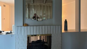 A room with a white fireplace, a mirror with a wooden frame, and a vase on the mantel. - Private 2 Bed 2 .5 Baths Spacious Condo (Palm Desert)