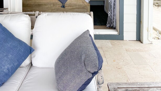 A room with a bed, a sofa, and a small table. - Ocean front loft. (Elbow Cay)