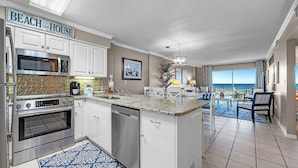 A modern kitchen with white cabinets, stainless steel appliances, and a granite countertop. - Gulf Shores Plantation-Palms 6402 (Gulf Shores)