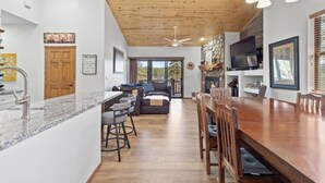 A spacious kitchen with a granite countertop, wooden ceiling, and a dining area with a large wooden table and chairs. - 5 🌟 Luxury Torreon  (Show Low)