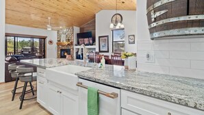 A modern kitchen with granite countertops, white cabinetry, and a wooden ceiling. - 5 🌟 Luxury Torreon  (Show Low)