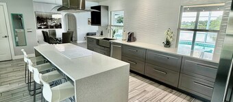 Escape to Paradise!Luxury Waterfront Heated Pool House with Game Room and Piano!