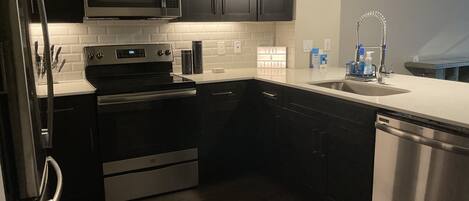 Microwave, dishwasher, coffee/tea maker, cookware/dishes/utensils