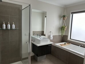 Bathtub, hair dryer, towels, soap