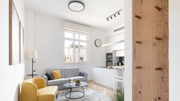A modern living room with a sofa, a yellow armchair, and a coffee table. - An amazing gem in the heart of TelAviv (Tel Aviv)