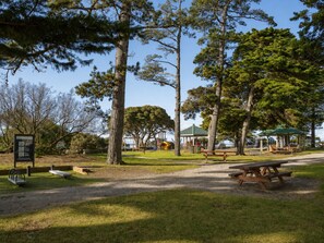 A park with picnic tables, a playground, and a gazebo. - Ocean View Penthouse by Ready Set Stay - Coastal Amazing Views & WIFI (Cowes)