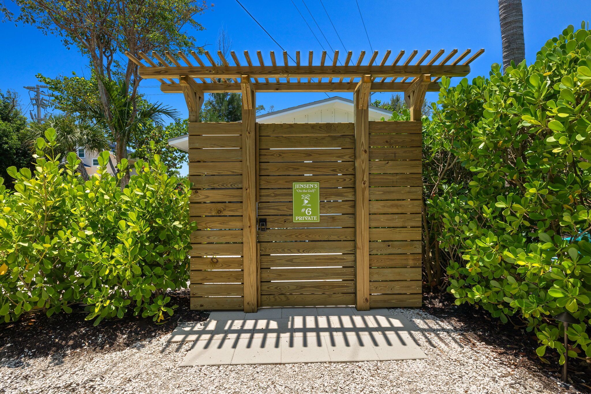 A wooden gate with a sign indicating it is private property.
