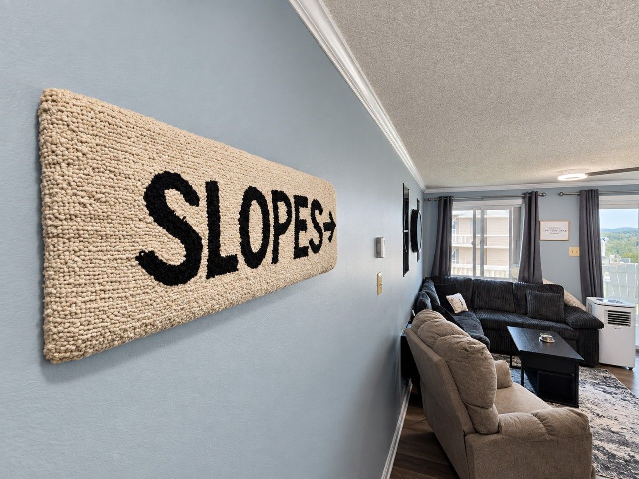A room with a large wall-mounted sign reading 'SLOPES+'.
