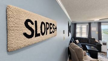 A room with a large wall-mounted sign reading 'SLOPES+'.