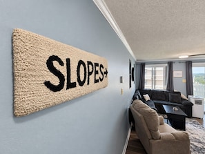 A room with a large wall-mounted sign reading 'SLOPES+'.