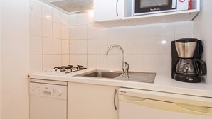 A compact kitchen with a gas stove, stainless steel sink, and a coffee maker. - Amazing home in Mejannes le Clap with swimming pool (Mejannes le Clap)