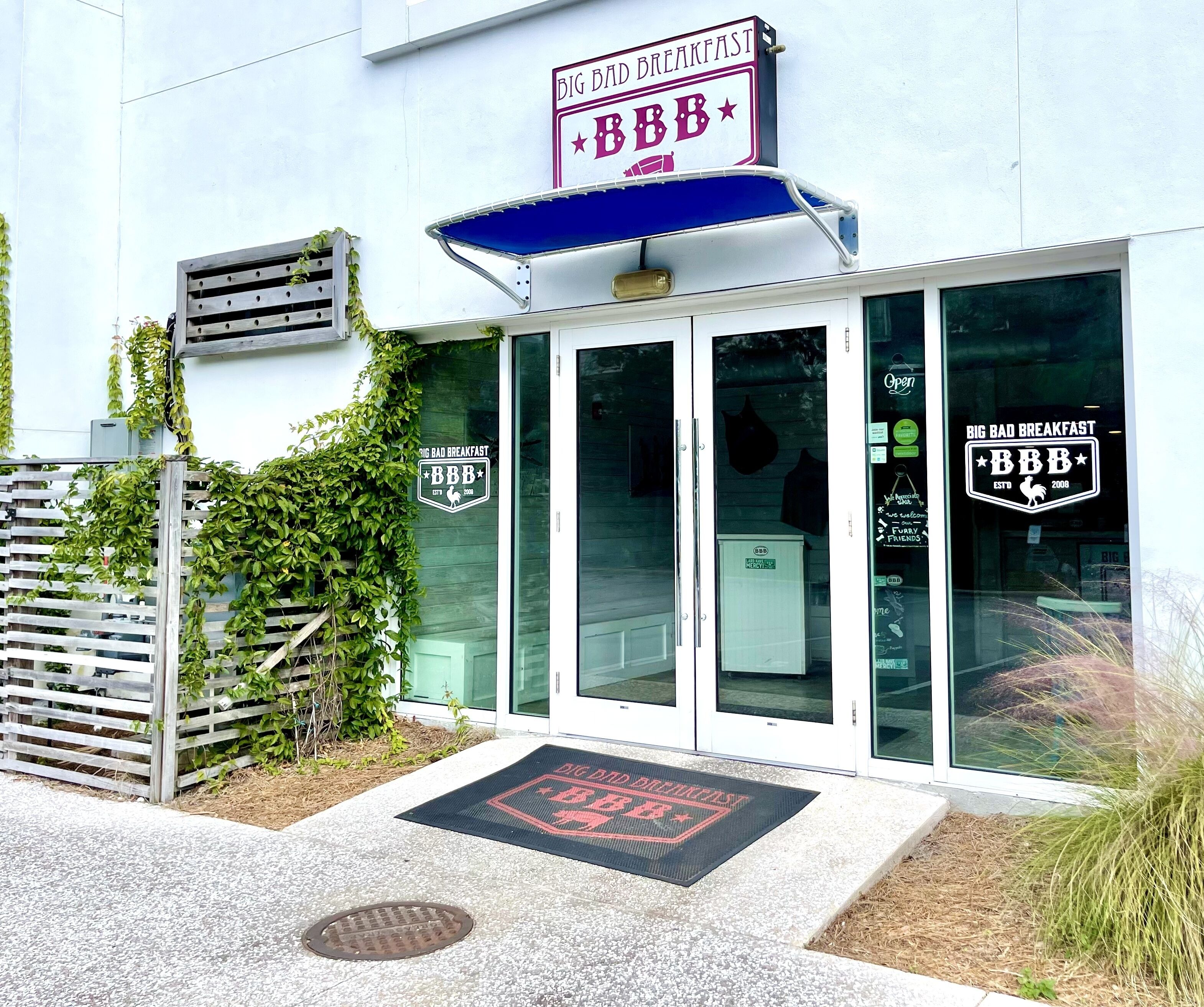 A building with a sign reading "BIG BAD BREAKFAST" and "BBB" logo, indicating a restaurant.